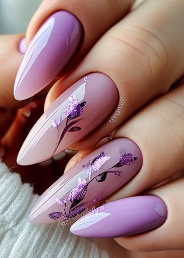 Stunning purple and mauve nail art with floral design on elegant almond-shaped nails.