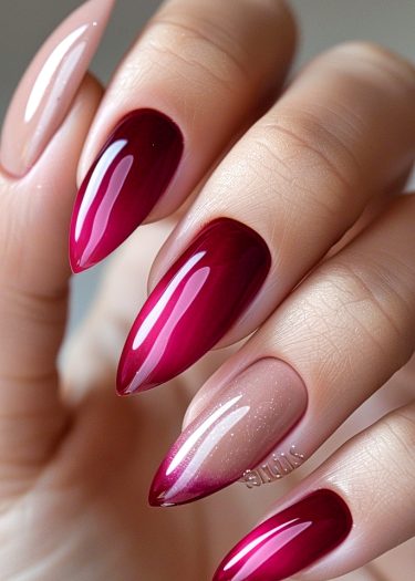 Stunning red and nude stiletto nails with rhinestones and glitter for a sophisticated look.