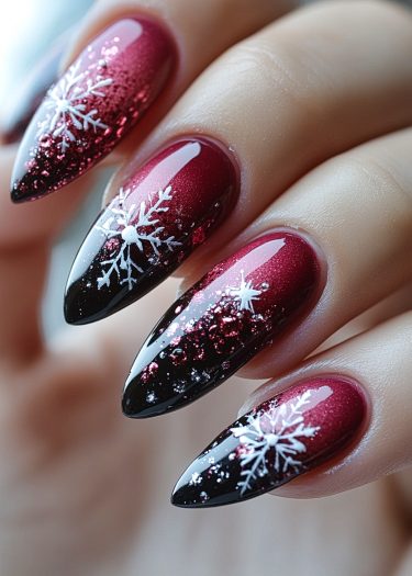 Elegant stiletto nails with burgundy to black gradient and festive snowflake designs.