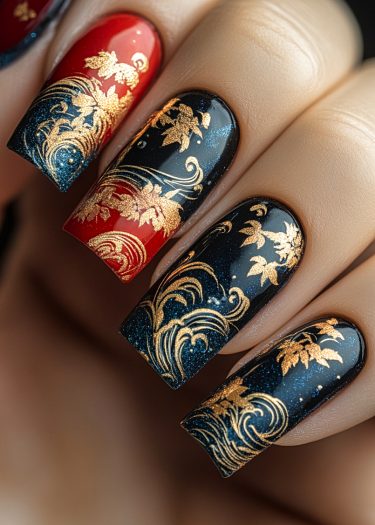 Luxurious red and black nail art featuring intricate gold patterns and floral designs.