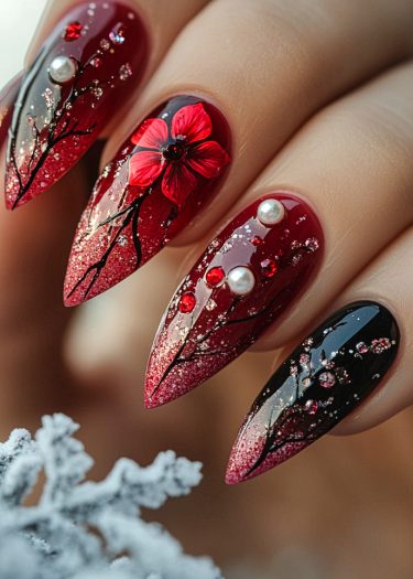 Stunning red and black stiletto nails with floral designs and wintery elements.