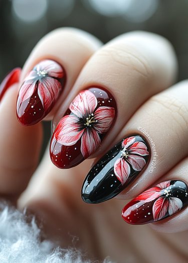 Elegant red and black almond-shaped nail art with detailed floral designs and glossy finish.