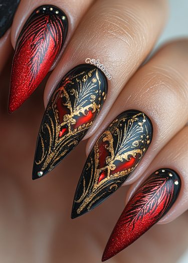 Elegant red and black almond-shaped nails with gold filigree and sparkling rhinestones.