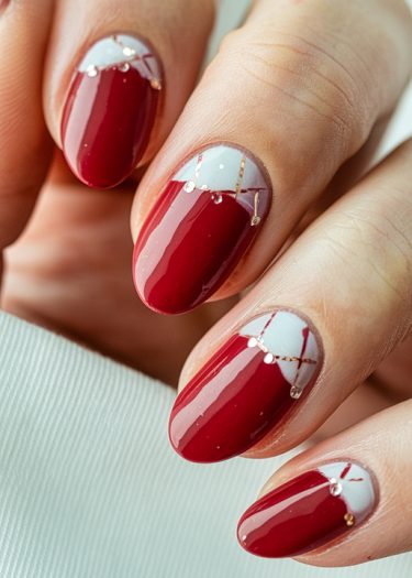 Stylish red nail art with gold accents for an elegant and sophisticated look.