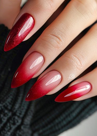 Elegant red ombre nails with a glossy finish showcase stunning nail art and sophistication.