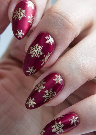 Elegant red snowflake nails showcase festive holiday designs and luxurious manicured artistry.