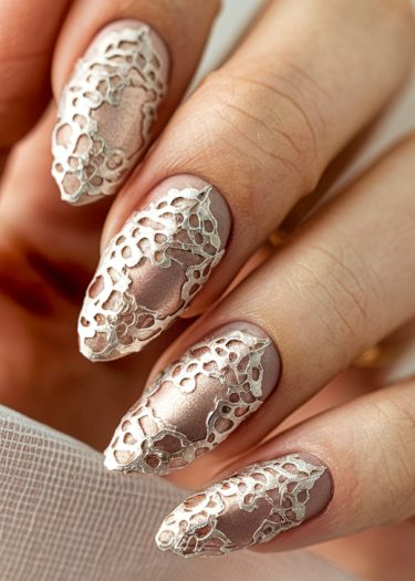 Elegant mauve almond nails featuring intricate metallic lace design for refined nail art.