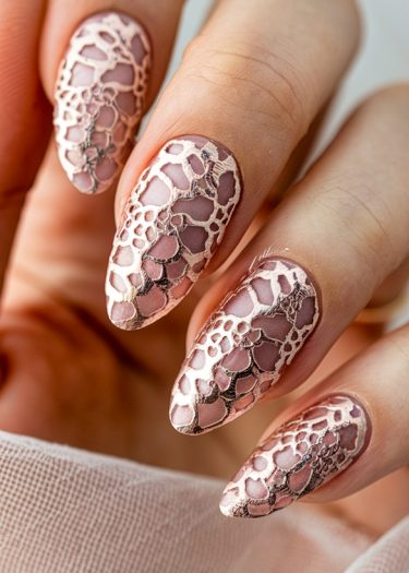 Exquisite rose gold lace nail art on almond-shaped nails in muted pink.