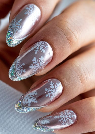 Elegant silver snowflake nail art design with glitter tips, perfect for a winter look.