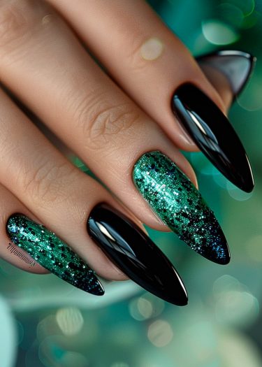 Elegant stiletto nails with glossy black and glittery green designs for stylish manicures.