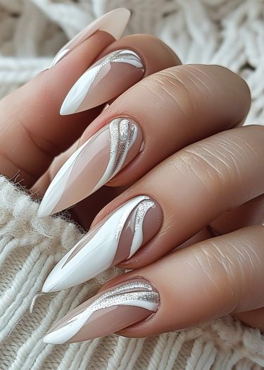 Elegant stiletto nail art with intricate designs and shimmering accents on a soft background.