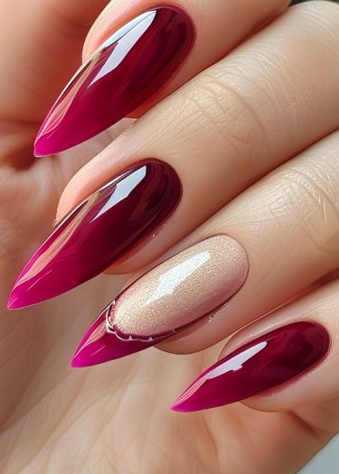 Elegant stiletto nail art featuring deep magenta and nude shimmer for a bold, sophisticated look.