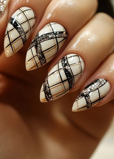 Sophisticated plaid almond nails in cream, black, and gold with glitter accents for elegance.