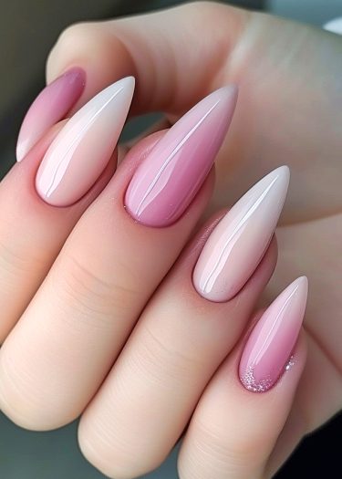 Elegant stiletto nails with a glossy ombre design in soft pink and white shades.