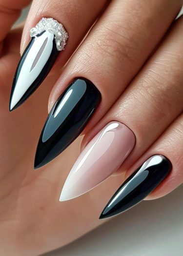 Elegant stiletto nails with glossy polish and unique embellishments in black, nude, and white.