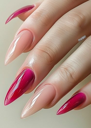 Stunning stiletto nails in fuchsia and nude tones showcase elegant manicure artistry.