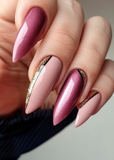 Stunning stiletto nails in plum and blush pink featuring gold foil accents and intricate designs.