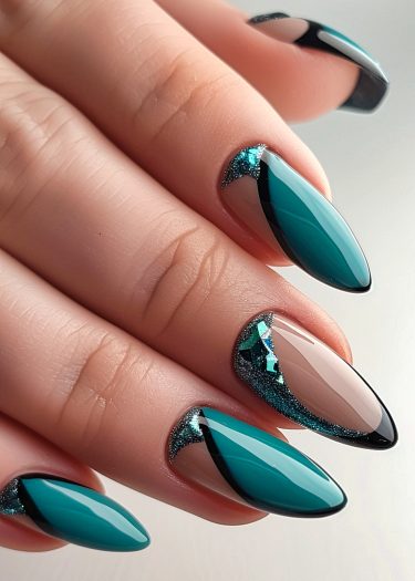 Exquisite teal almond nails with stunning geometric art and shimmering accents for a luxurious look.