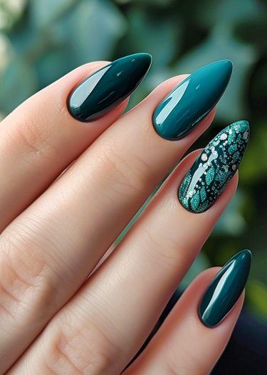 Elegant teal almond nails with intricate designs and rhinestones for a glamorous look.