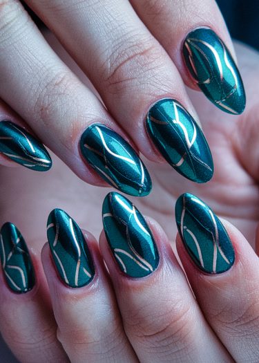 Elegant teal nail art featuring intricate gold line designs for a sophisticated look.