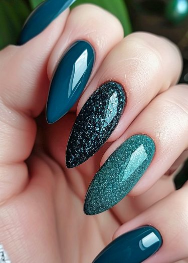 Elegant teal almond nails with glittery designs and glossy finishes showcase sophisticated nail art.