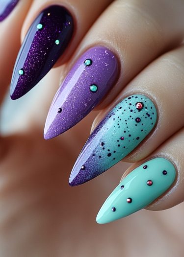 Vibrant stiletto nail art featuring shimmering purples and sparkling embellishments for a bold look.