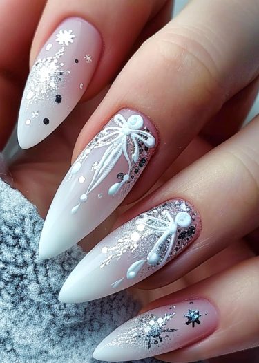 Elegant winter nail art featuring snowflakes and glitter on almond-shaped nails.