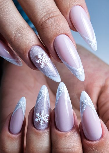 Elegant winter stiletto nails with 3D snowflakes and chic V-shaped French tips.