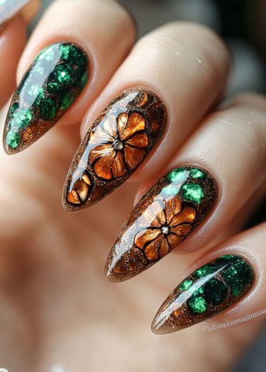 Elegant emerald and bronze floral nail art with intricate designs and a glossy finish.