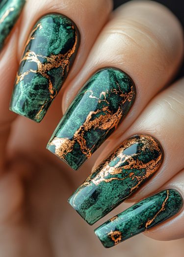 Elegant dark green nails with gold marbling, showcasing luxurious nail art design.