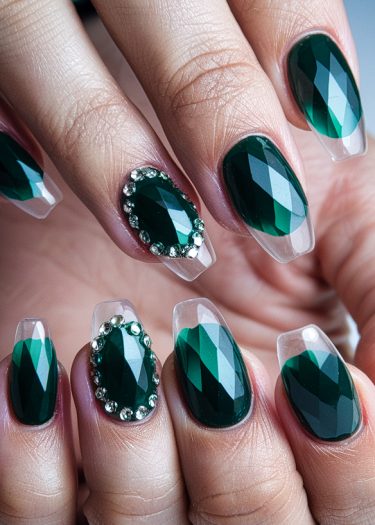 Luxurious emerald gemstone nail art with rhinestones for a sophisticated manicure look.