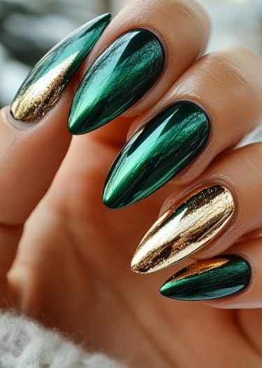 Elegant emerald and gold metallic nails in an elongated almond shape for a chic look.