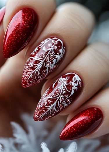 Glamorous festive red glitter nails with intricate white designs for a stunning winter manicure.