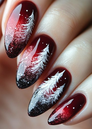 Elegant red and black ombre nail art design with winter tree and snowflake details.