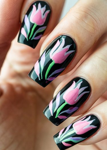 Elegant floral nail art on a glossy black base featuring pink tulips and green accents.