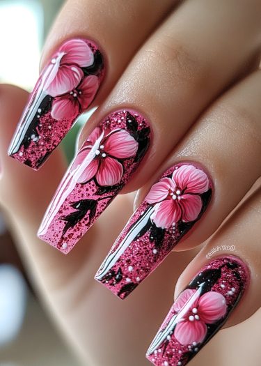 Glamorous pink glitter floral nail design with intricate details and bold black accents.