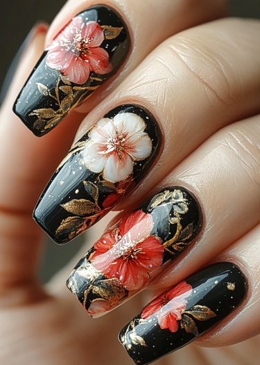 Elegant floral nail art featuring vibrant blossoms and gold accents on a glossy black background.