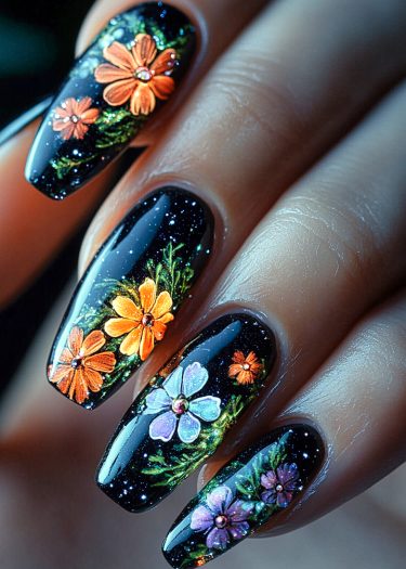 Elegant black floral nail art featuring vibrant flowers and shimmering accents for a stunning design.