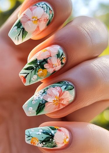 Beautiful floral nail art on mint green base with vibrant colors and intricate designs.