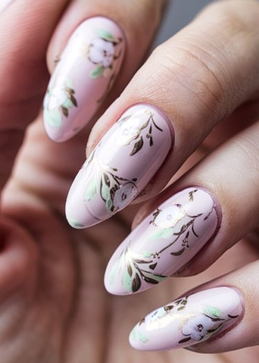 Elegant pastel pink floral nail art with intricate designs and gold detailing.