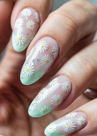 Elegant mint green floral nail design with daisies and subtle glitter accents.