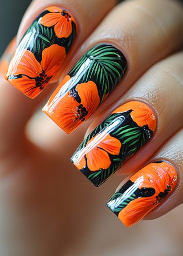 Vibrant orange tropical floral nail art on glossy black background for exquisite summer style.