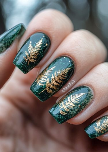 Elegant forest green nails with gold fern designs and a glossy finish.