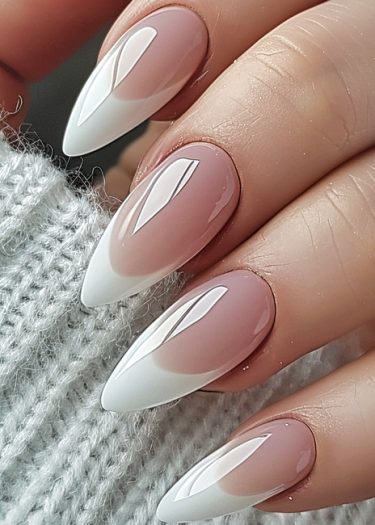 Elegant French ombre manicure with glossy stiletto nails and well-groomed cuticles.