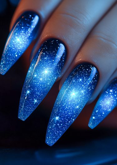 Stunning galaxy nail art featuring cosmic gradients and shimmering stars on elegant, long nails.