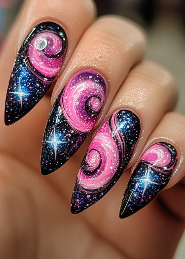 Galaxy-themed nail art featuring swirling pink and purple designs with glittering stars on black nails.