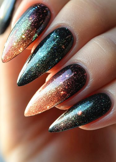 Elegant galaxy stiletto nails featuring a vibrant gradient and dazzling glitter design.