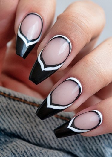 Stylish coffin-shaped nude nails featuring geometric black and white designs for a modern manicure.