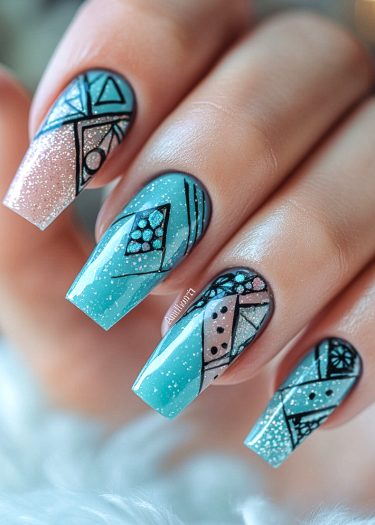 Intricate geometric blue nail art featuring vibrant patterns and sparkle accents.