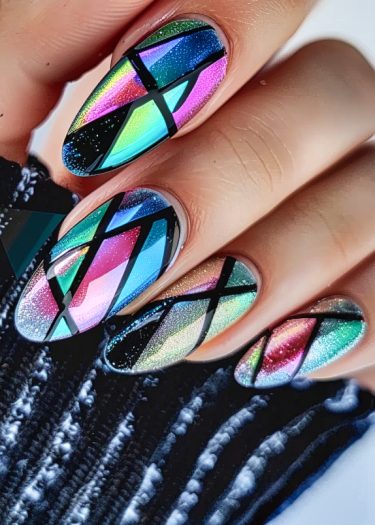 Vibrant geometric nail art with rainbow colors and holographic shimmer on almond-shaped nails.